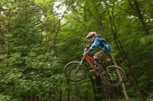 Catching air on a mountain bike trail - © Crown Copyright - Forestry Commission / Isobel Cameron